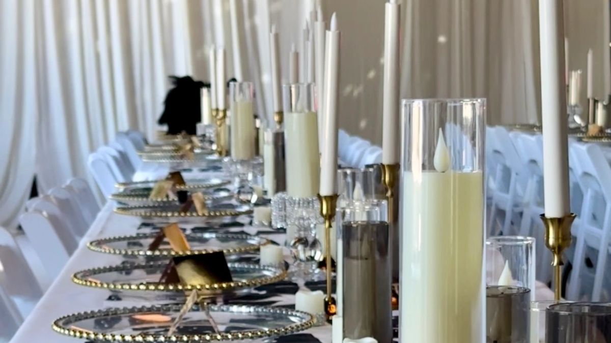 Table settings under hanging greenery